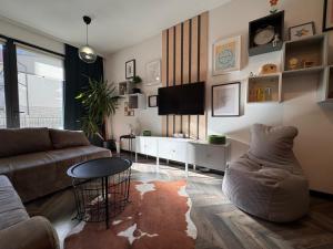 a living room with a couch and a table at Bylinkový Apartmán in Banská Bystrica