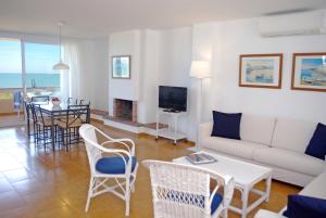 a living room with a couch and a table at Apartamentos Golf Mar I & II by La Costa Resort in Pals