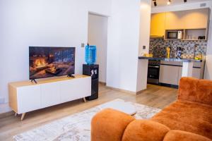 a living room with a couch and a tv at Moonlight mirage in Nairobi