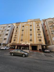 a car parked in a parking lot in front of a building at comfort suite in Jeddah