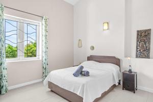 a bedroom with a bed with a camera on it at Domaine Harmonia - Group Retreat by Sealodge Mauritius in Rivière Noire