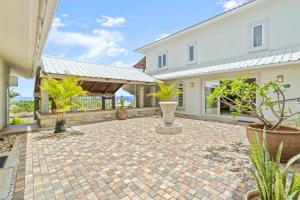 a courtyard with potted plants and a house at Domaine Harmonia - Group Retreat by Sealodge Mauritius in Rivière Noire