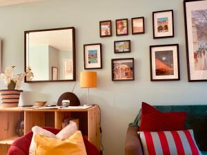 a living room with a mirror and a couch at Peaceful 2 Bed Home with Parking Fast WIFI Easy Stress-Free Access to Bath in Bath