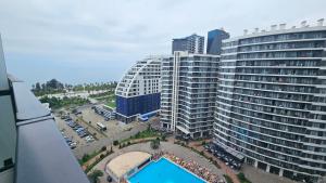 an aerial view of a large building with a pool at Студия в White Sails видовая in Batumi