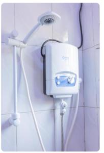 a shower head on the wall of a bathroom at Javelin Palace Hotel in Kampala