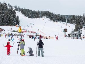 a group of people on a snow covered ski slope at Les bleuets in Bolquere Pyrenees 2000
