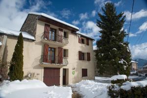 a building with snow in front of it at Les bleuets in Bolquere Pyrenees 2000