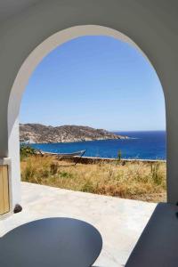 an archway with a view of the ocean at The endless blue experience in Ios Chora