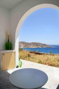 a room with a table and a view of the ocean at The endless blue experience in Ios Chora