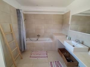a bathroom with a bath tub and a sink at villa La Néoulaise in Néoules +22 photos