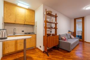 a kitchen with a couch and a table in a room at La Casetta Vintage - Base Milan Cortina 2026 in Bormio