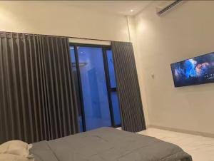 a bedroom with a bed and a sliding glass door at Villa Velare 03 dharmahusada indah galaxy mall in Surabaya