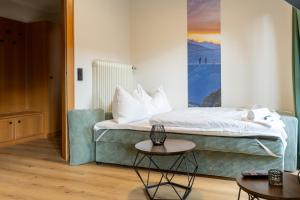 a hotel room with a bed and a table at Bergblick Appartements in Bad Gastein