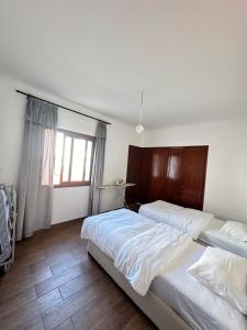 a bedroom with two beds and a window at Apartamento in M'diq +48 photos