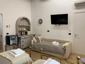 a living room with a couch and a flat screen tv at CASCINA LAI - Oasi Naturalistica - Camere private in Santena