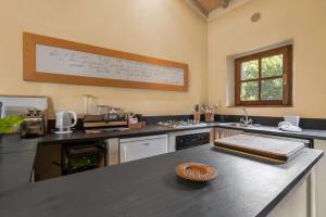a kitchen with a counter with a whiteboard on the wall at Casa Dell'Ambasciatore in Vivo dʼOrcia