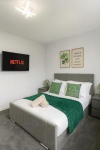 a bedroom with two beds with green and white at Luxury Airport Home with Driveway and Garden- Sleeps 7 in Ashley