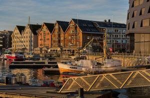 a group of boats docked in a harbor with buildings at Smarthotel Tromsø in Tromsø