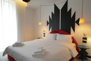 Postel nebo postele na pokoji v ubytování Bazaar Hotel