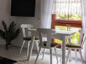 a table and chairs in a room with a window at Ferienwohnung Hollerberg in Schwarzenberg/Erzgebirge