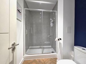 a glass shower in a bathroom with a toilet at The Post House One by Fortuna Property in Gloucester