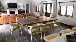 a living room with a wooden table and chairs at Landrift Villa in Phalaborwa