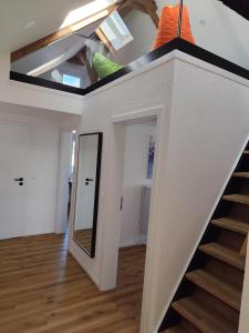 a room with a staircase and a mirror at FeWo Relaxfit in Bad Buchau
