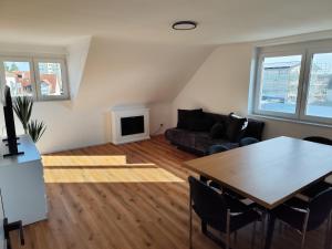 a living room with a table and a couch at FeWo Relaxfit in Bad Buchau