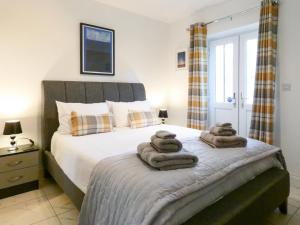 a bedroom with a bed with towels on it at Railway Cuttings in Falstone