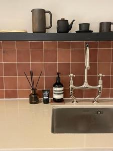 a kitchen counter with a sink next to a counter top at stay early mansion 가산, 홍대, 고척돔 in Seoul