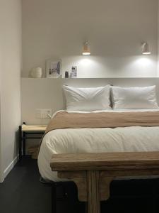 a bedroom with a large bed with white sheets and pillows at stay early mansion 가산, 홍대, 고척돔 in Seoul