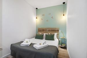 a bedroom with two towels on a bed at Central Studio – Flor De Sol in Tavira