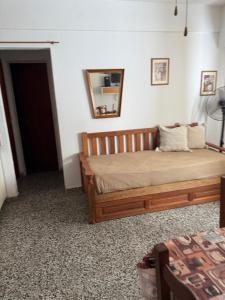 a bedroom with a bed and a mirror on the wall at Departamento céntrico en San Bernardo in San Bernardo