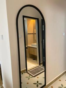 a mirror in a bathroom with a sink at Artesano one bedroom cozy and comfortable in Syokimau