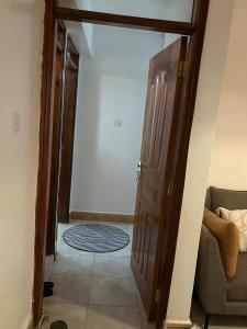 an open door to a living room with a couch at Loresho Luxe stay in Nairobi