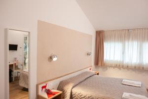 Un pat sau paturi într-o cameră la Hotel Giardino