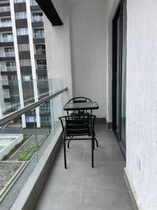 a table and chair on the balcony of a building at Artesano one bedroom cozy and comfortable in Syokimau