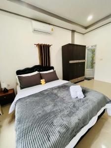 a bedroom with a large bed with two towels on it at Cozy Hideaway 2 BR in Ban Ta Khun +17 photos