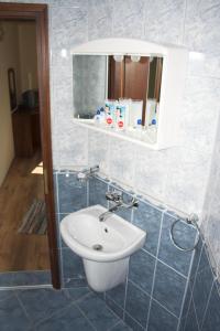a bathroom with a sink and a mirror at Hotel Old Times in Asenovgrad