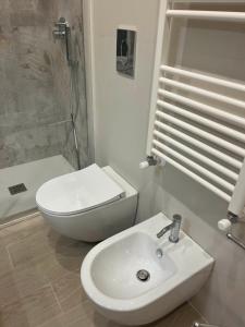 a bathroom with a sink and a toilet and a shower at Nancy's Home in Naples +7 photos
