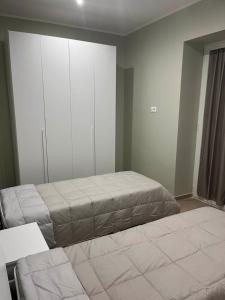 a bedroom with two beds and a closet at Nancy's Home in Naples