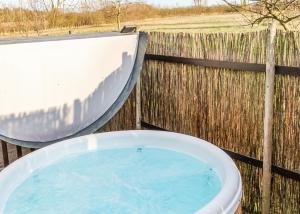 a large tub of water next to a slide at Laxfield Lodges in Laxfield