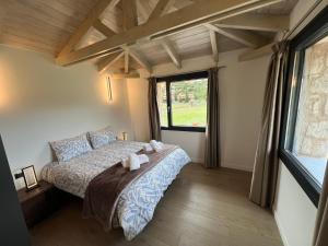 a bedroom with a bed with towels on it at Arachova Villa Paris in Kalívia