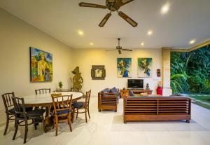 a dining room with a table and chairs at Arjuna Villa 3 Bedroom Villa Seminyak in Seminyak