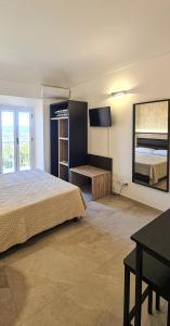 a bedroom with a bed and a desk in it at Borgo Marchetti in Camerano