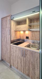 a kitchen with wooden cabinets and a sink at Borgo Marchetti in Camerano