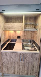 a kitchen with a stainless steel sink and wooden cabinets at Borgo Marchetti in Camerano +21 photos