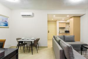 a living room with a couch and a table at DOMO By Design Union in Lagos