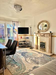 ein Wohnzimmer mit Kamin und Fernseher in der Unterkunft 2-Bed House Sleeps 4 Garden 10 mins to Anfield in Liverpool
