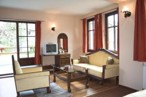a living room with a couch and a coffee table at Hotel Old Times in Asenovgrad